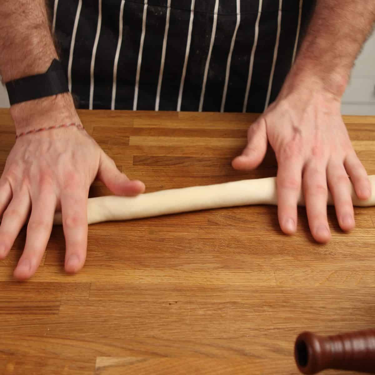 Rolling out dough on table.