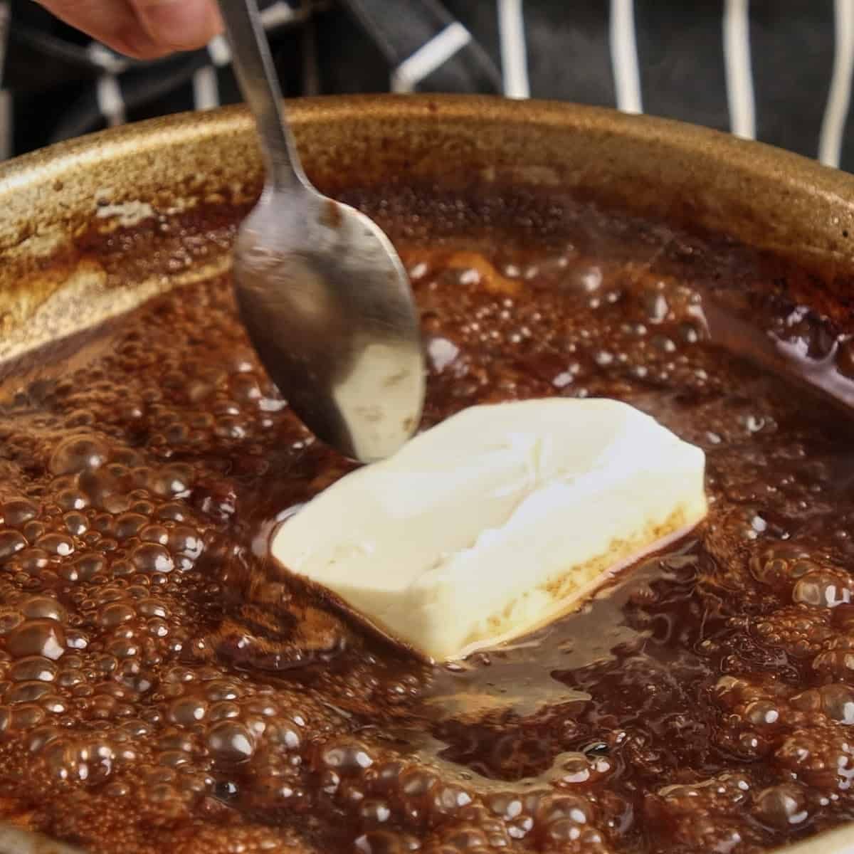 Adding butter to Onion gravy.