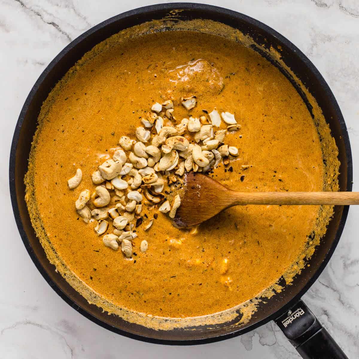Roasted cashew nuts added to butter chicken sauce.