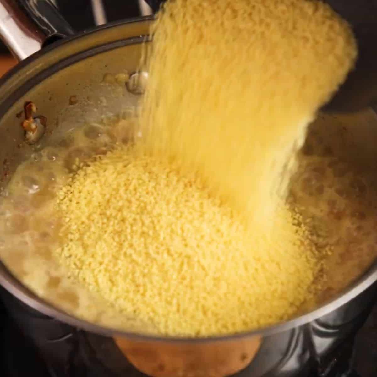 Adding couscous to liquid.