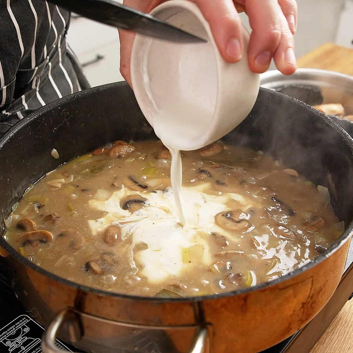 Adding cream to chicken velouté.