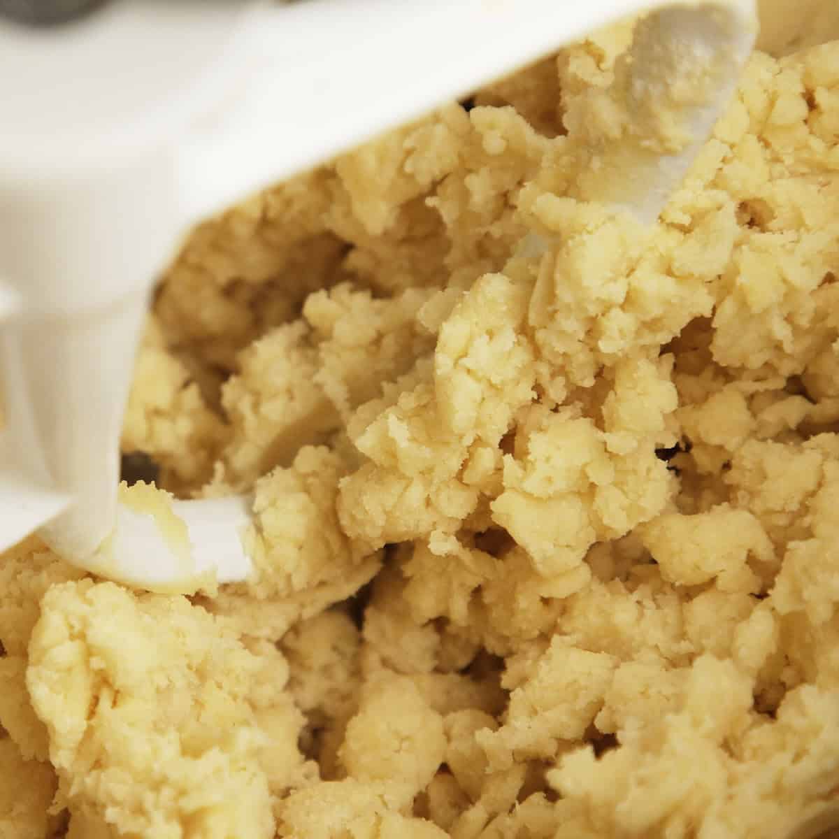 Short crust pastry mixing in a metal bowl.