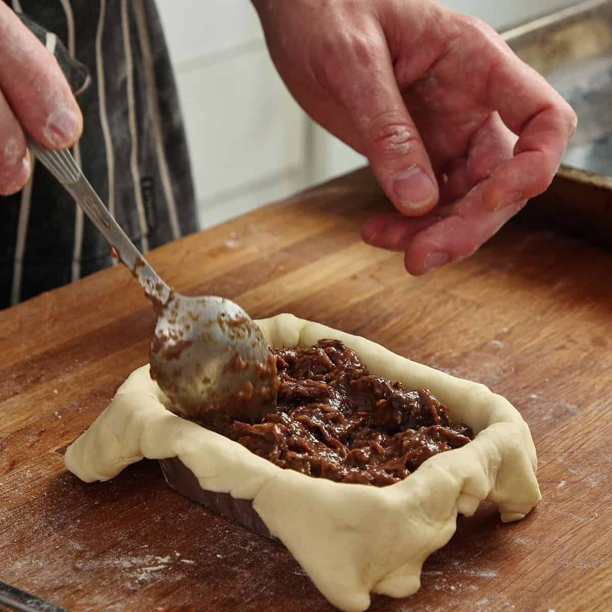 Adding pie filling to lined pie tin.