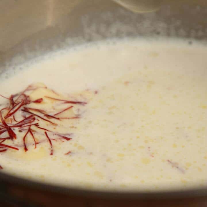 Adding saffron to cream and butter in a pan.