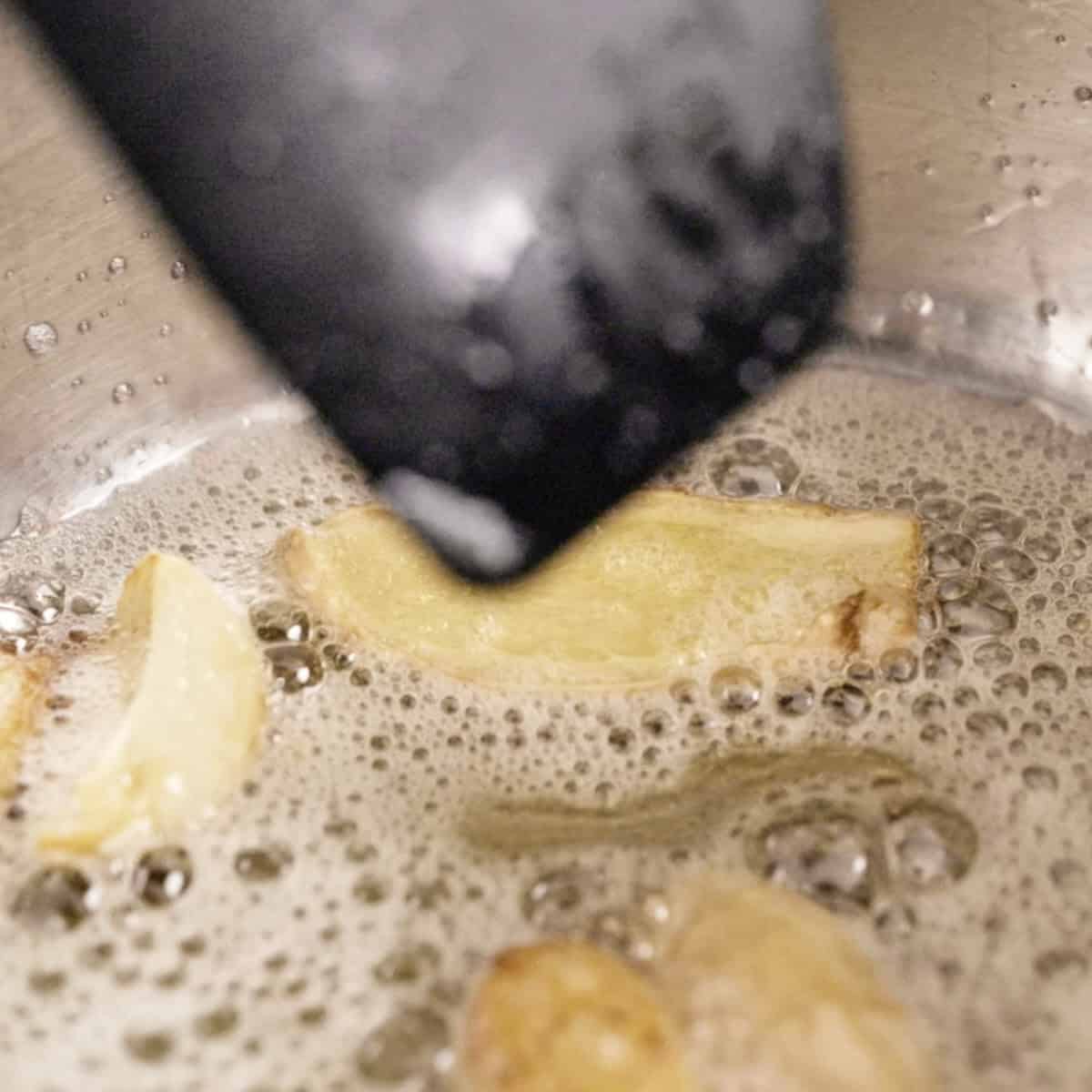Frying aromatics for chicken fat rice in a sauce pan.
