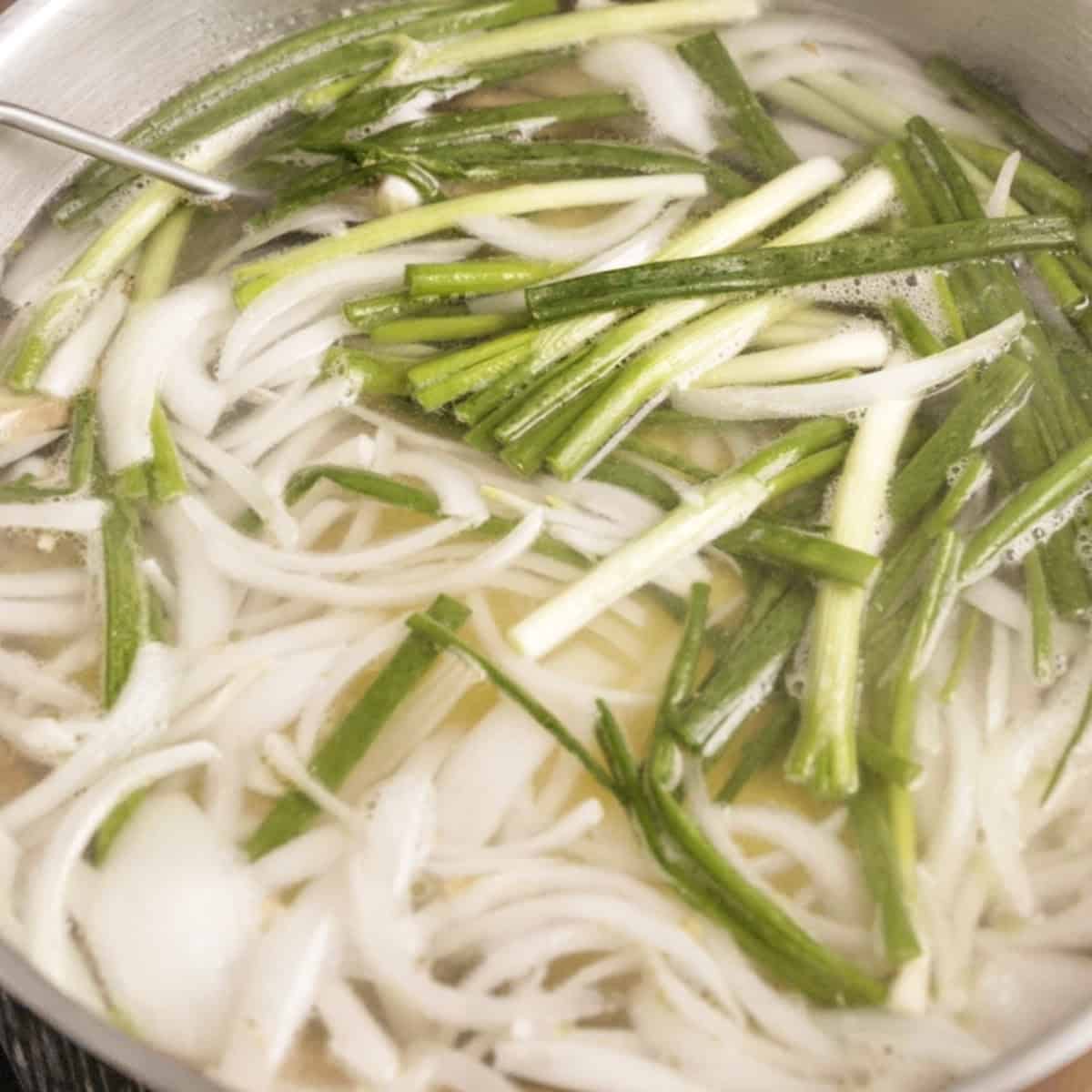 Ingredients in a pot for poaching hainanese chicken.
