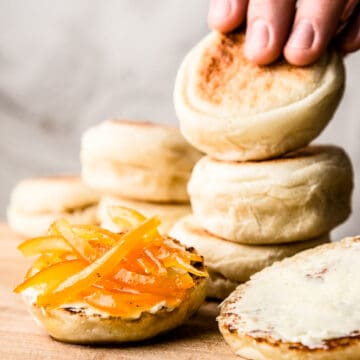 English muffins on wooden board.