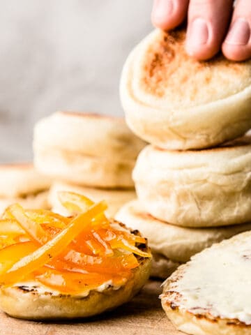 English muffins on wooden board.