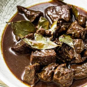 Beef adobo in white ceramic bowl.