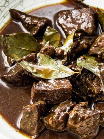 Beef adobo in white ceramic bowl.