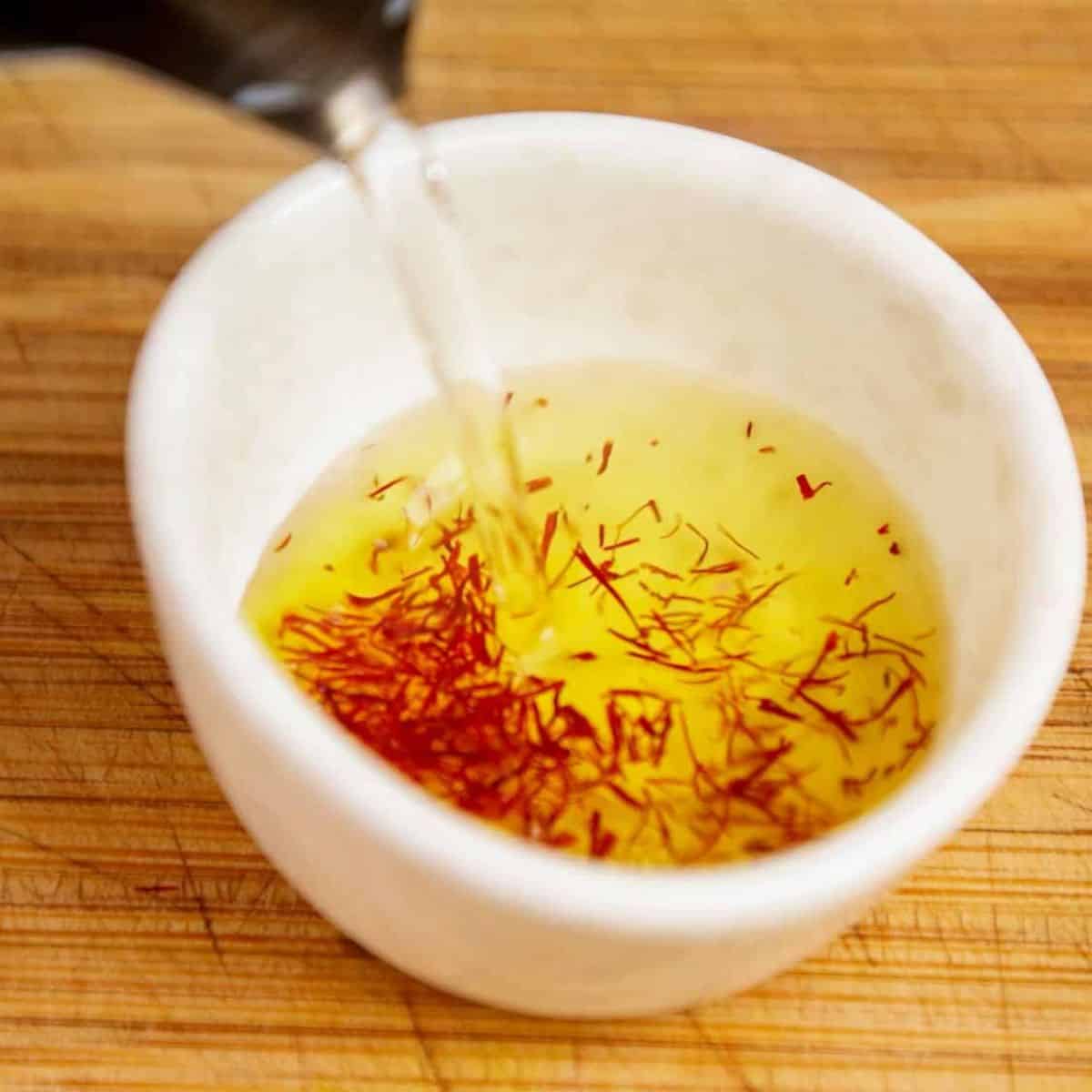Adding boiling water to saffron.