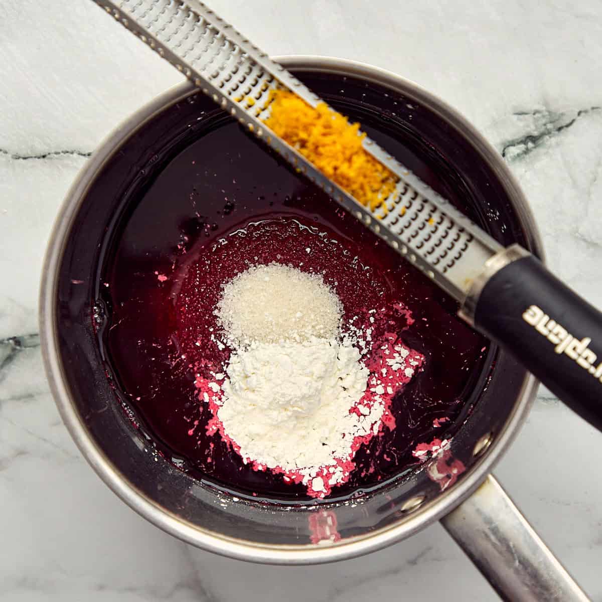 Ingredients for cherry jam in a pot.