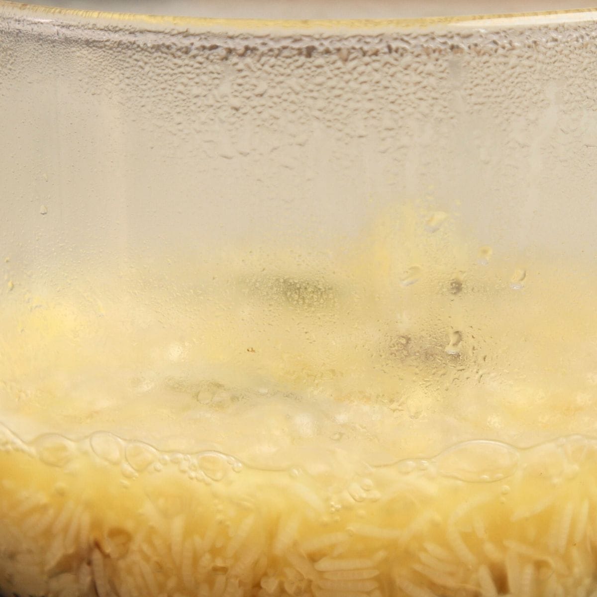 Rice par boiling in stock with spices.
