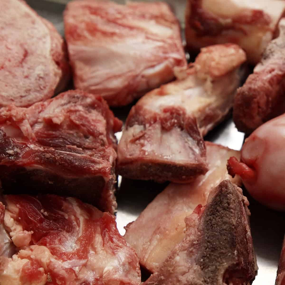 Beef bones for stock on a tray.