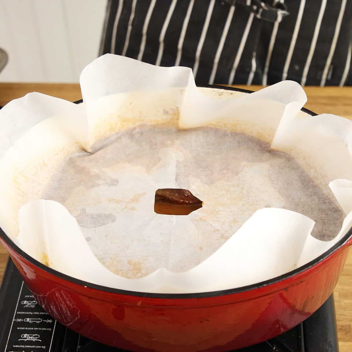 Cartouche on top of braise before being cooked.