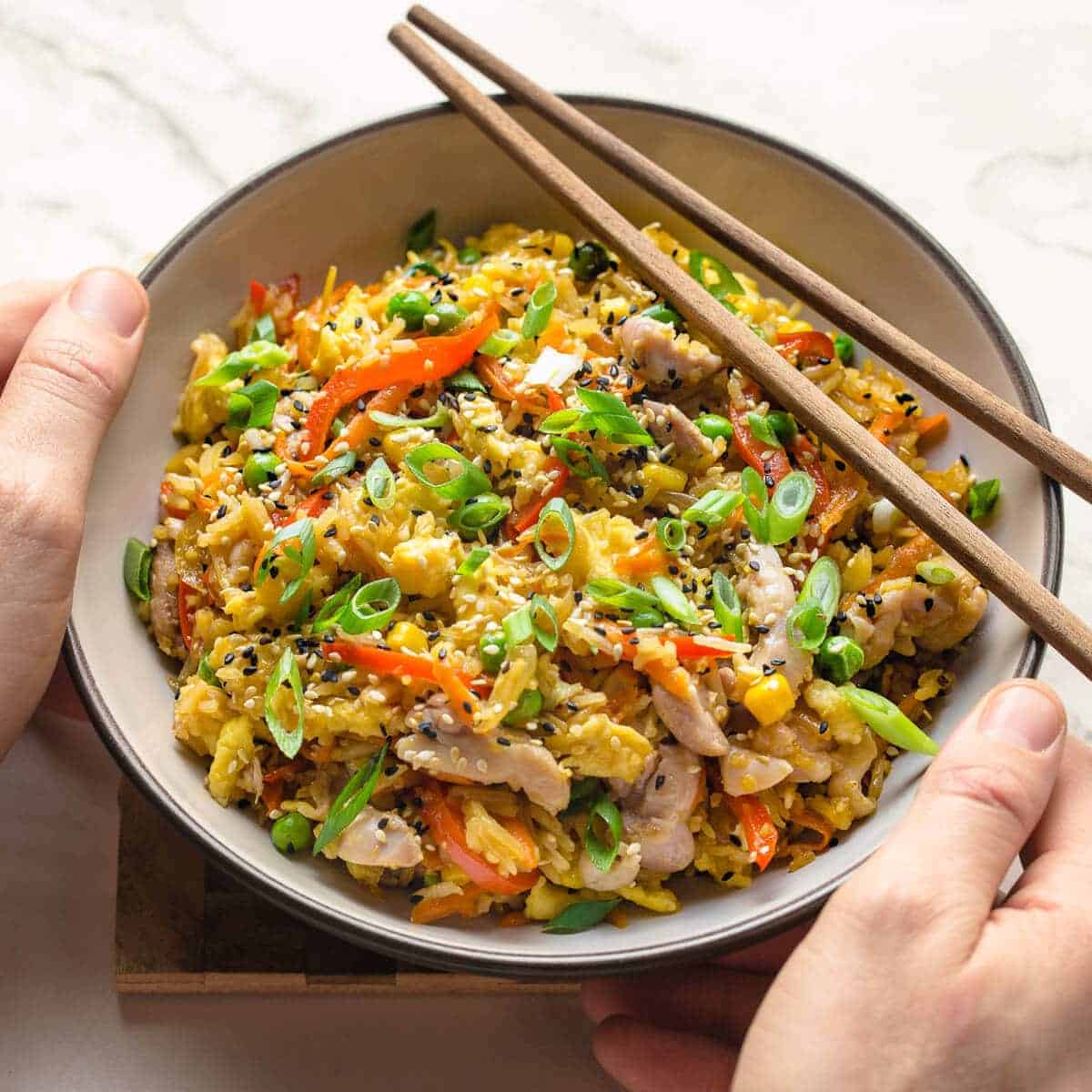 chicken fried rice in a bowl with chopsticks