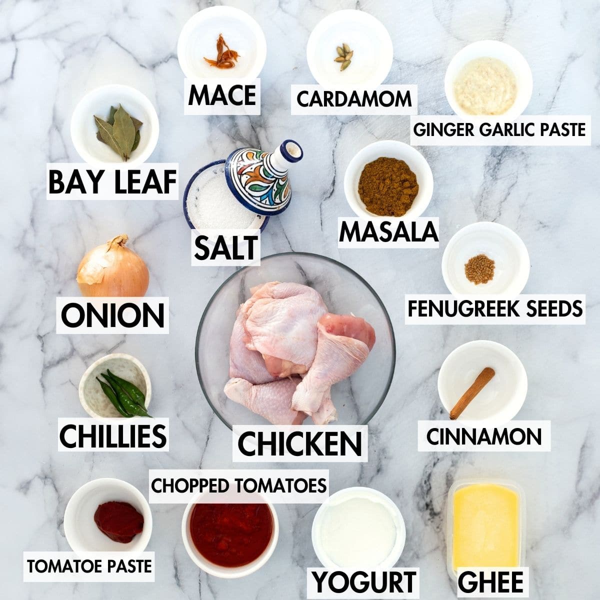 Ingredients for making biryani gravy on a marble surface.