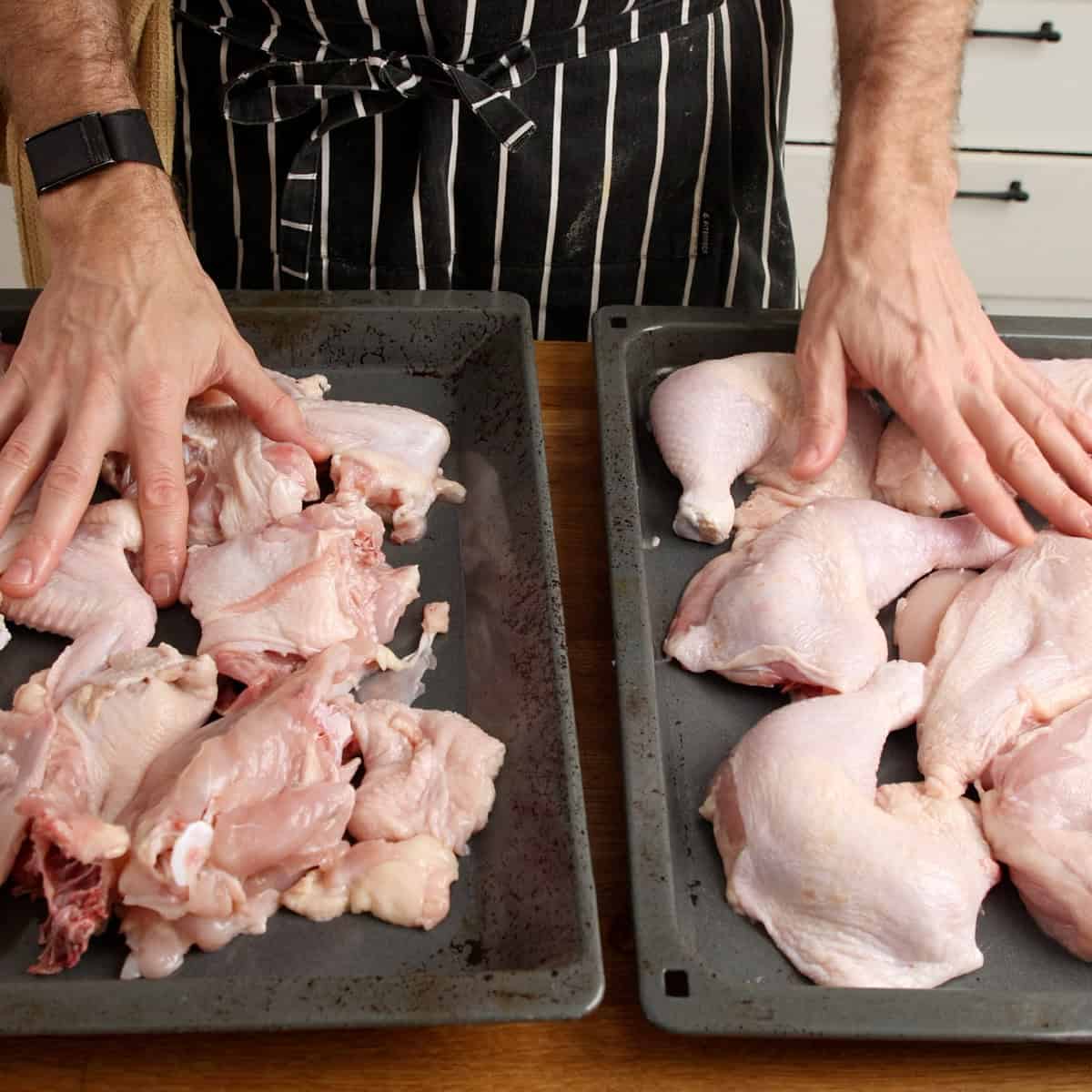 Chicken pieces on oven trays.