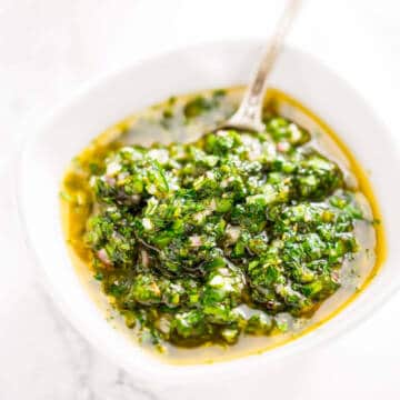 Green sauce in a white bowl.