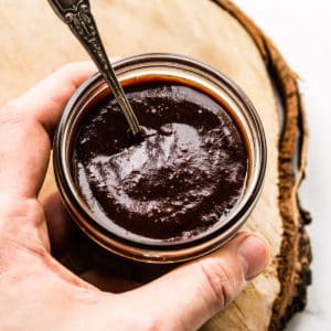BBQ sauce in a kilner jar with spoon.