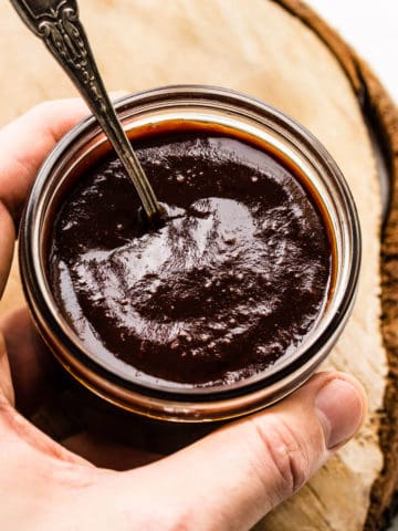 BBQ sauce in a kilner jar with spoon.