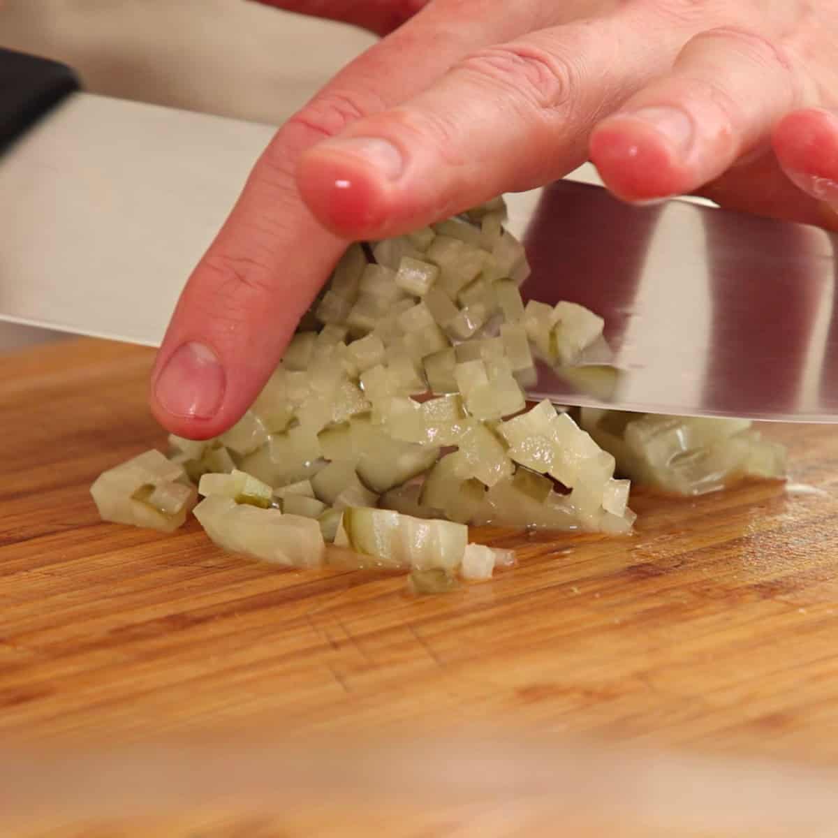 Chopping pickles for fish filling.