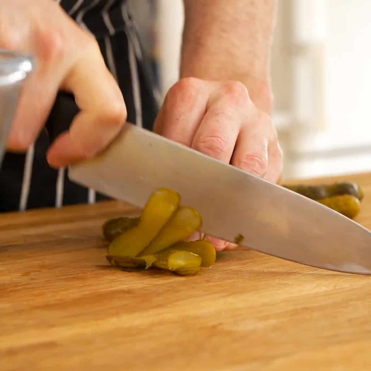 Chopping pickles or cornichons.