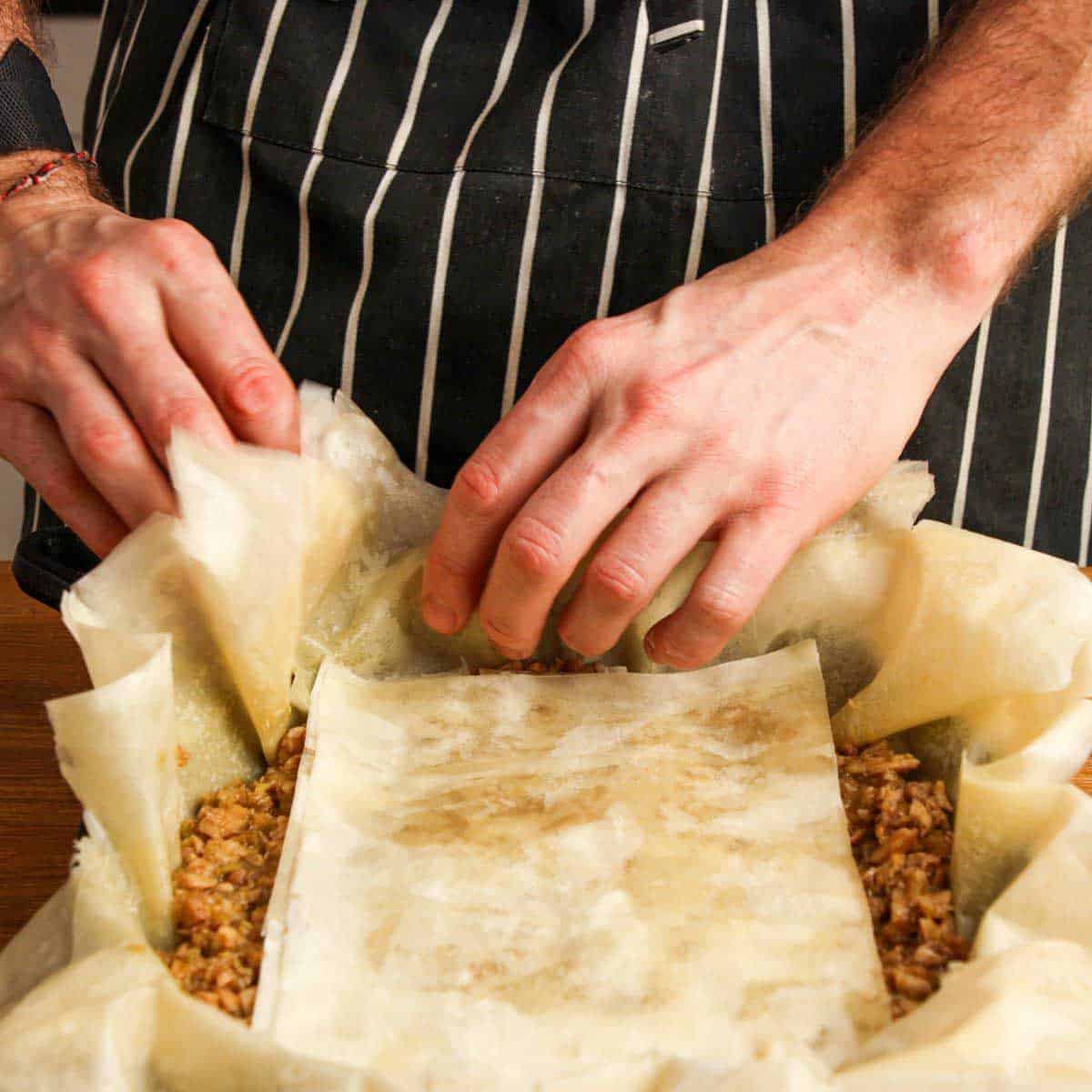 Closing the pastilla with phyllo before baking.