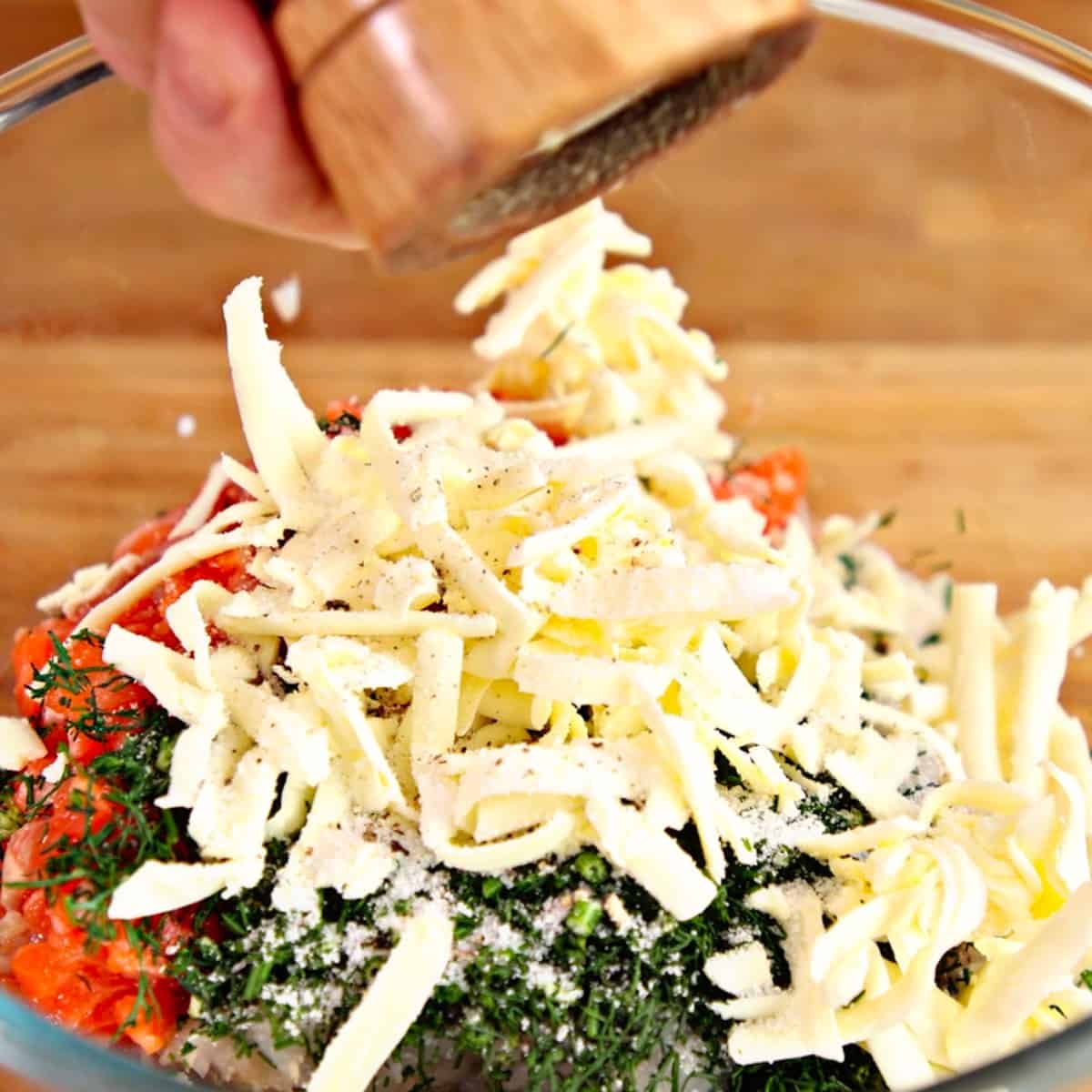 Grated butter in a bowl with dill, fish, shrimp and soaked breadcrumbs.
