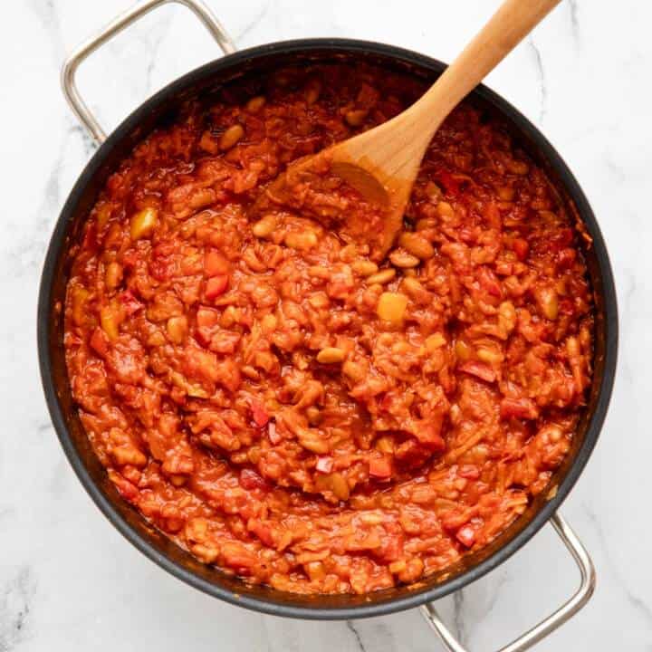 Chakalaka simmering in a black pan.