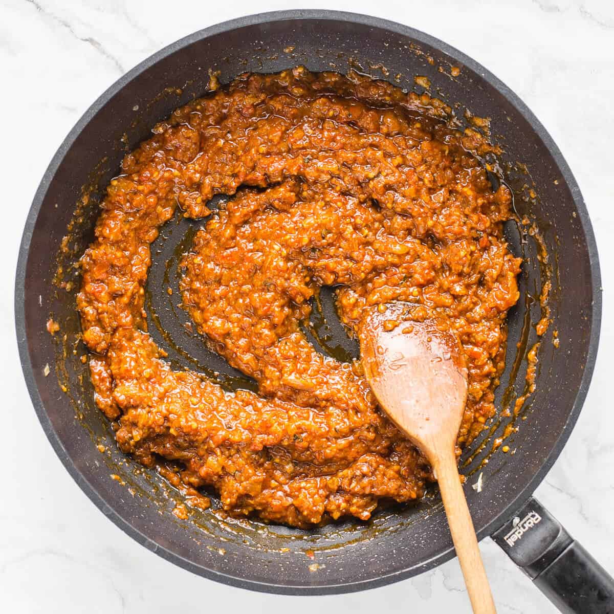 Chopped tomatoes added to the curry base.
