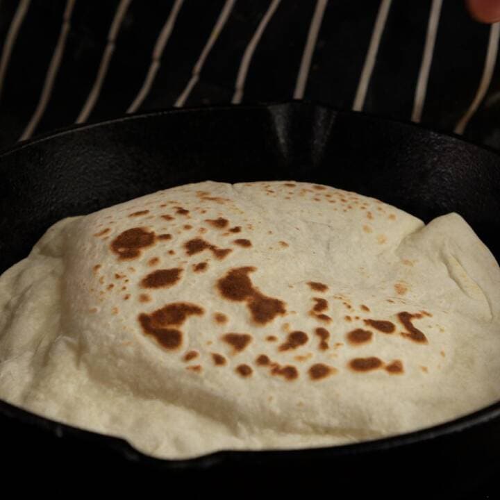 Flatbread cooking in a skillet.