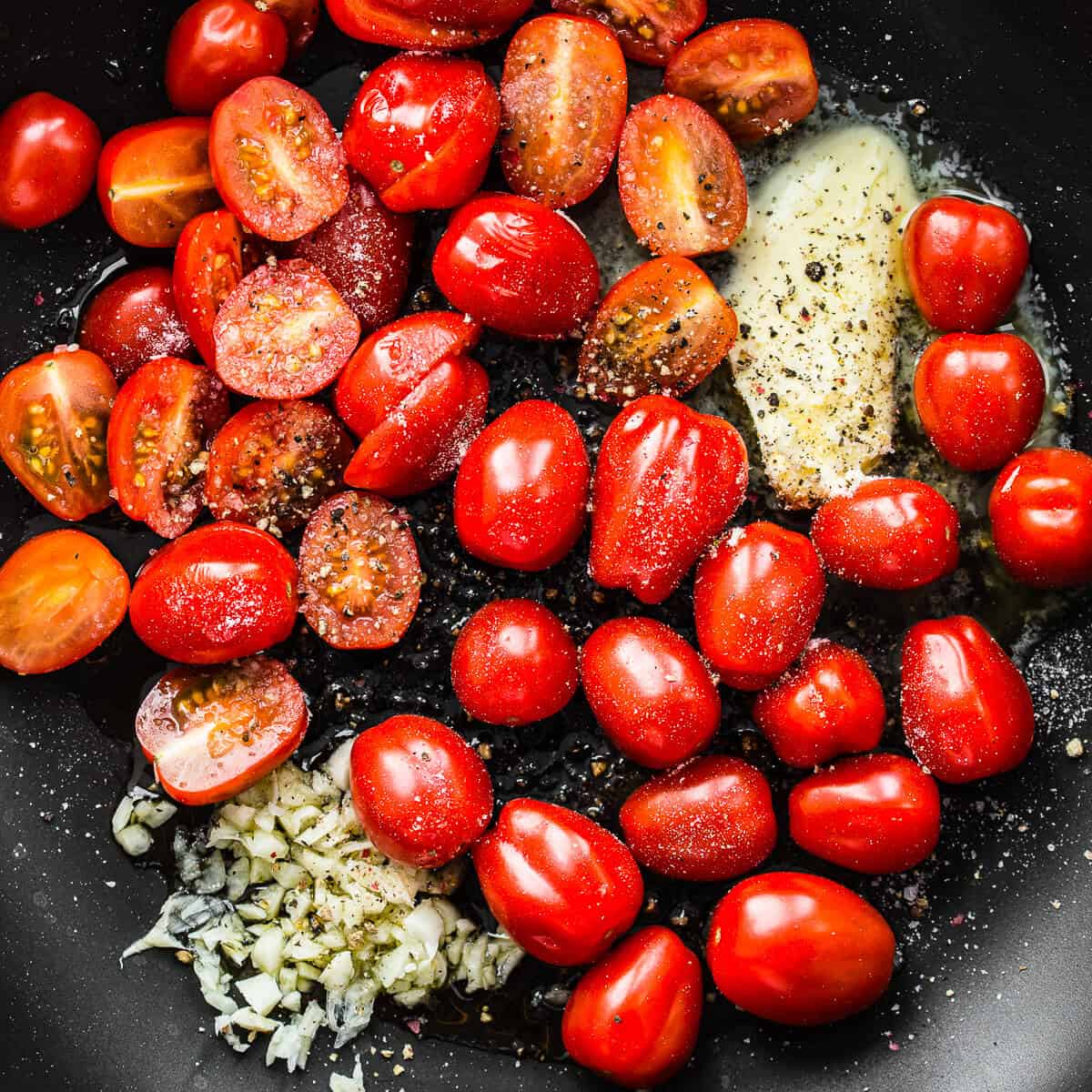 Tomatoes, garlic and butter in a pan for cooking.