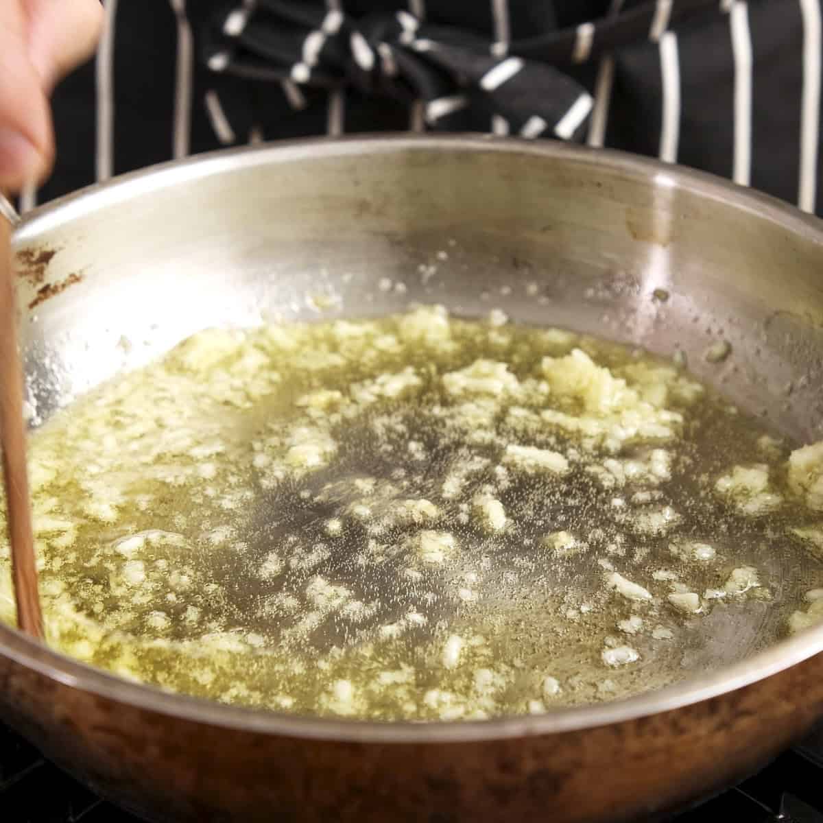 Garlic butter cooking in a pan.