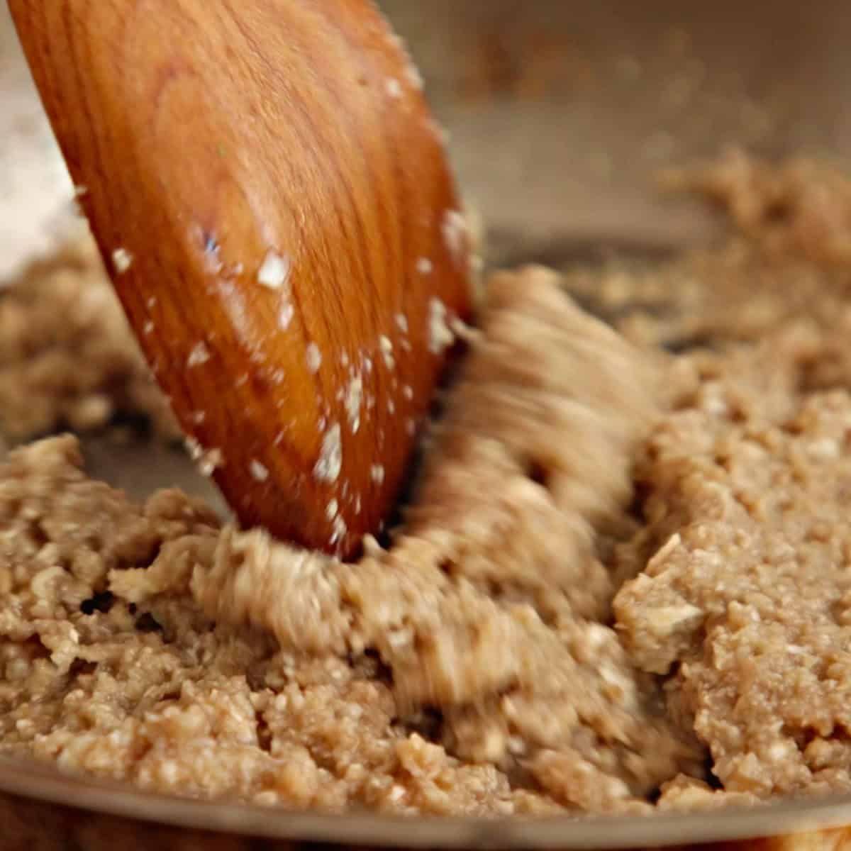 Cooking blended mushrooms in a pan.