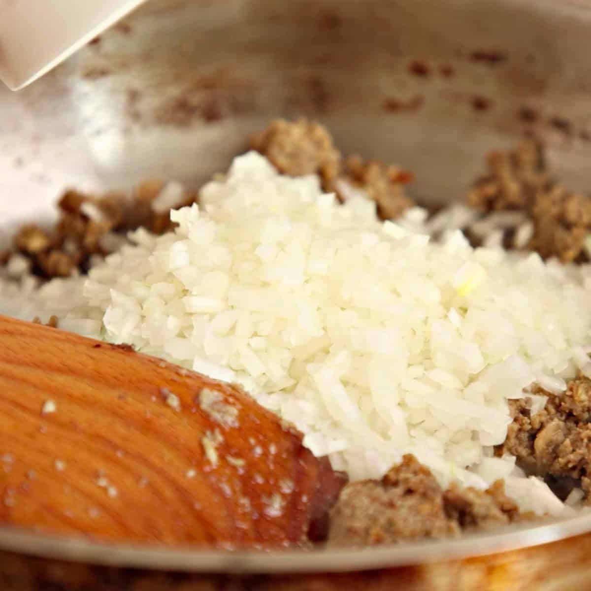 Cooking chopped onions in a pan.
