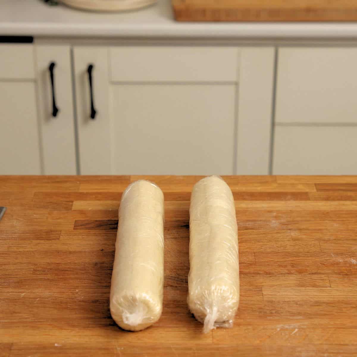 Logs of pastry wrapped in plastic.