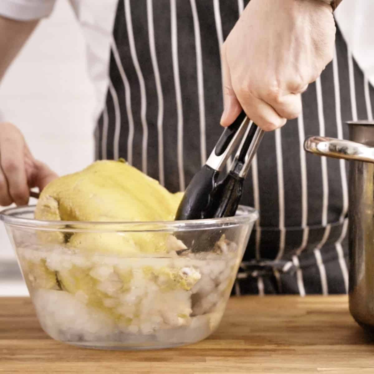 Cooling down poached chicken in ice water.