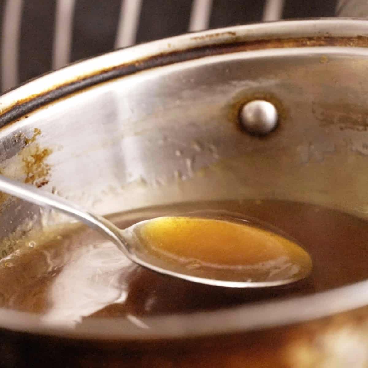 Thickened soy chicken broth gravy in a sauce pan.