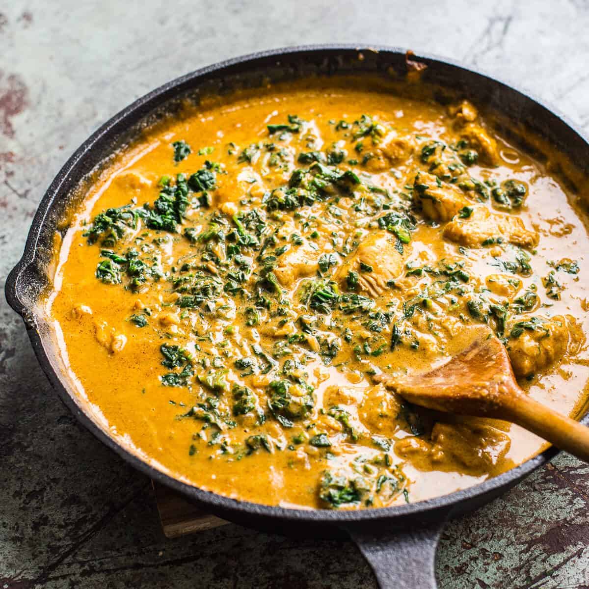 coconut chicken curry in black skillet.