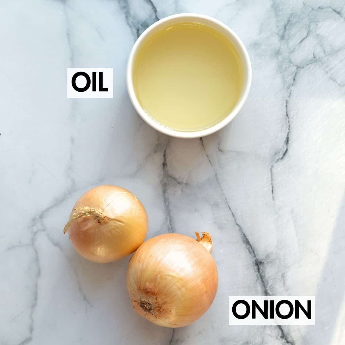 Ingredients for making cripsy onions on a marble surface.