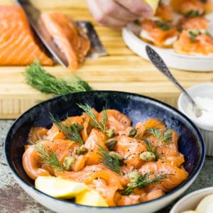 sliced cured salmon in blue bowl