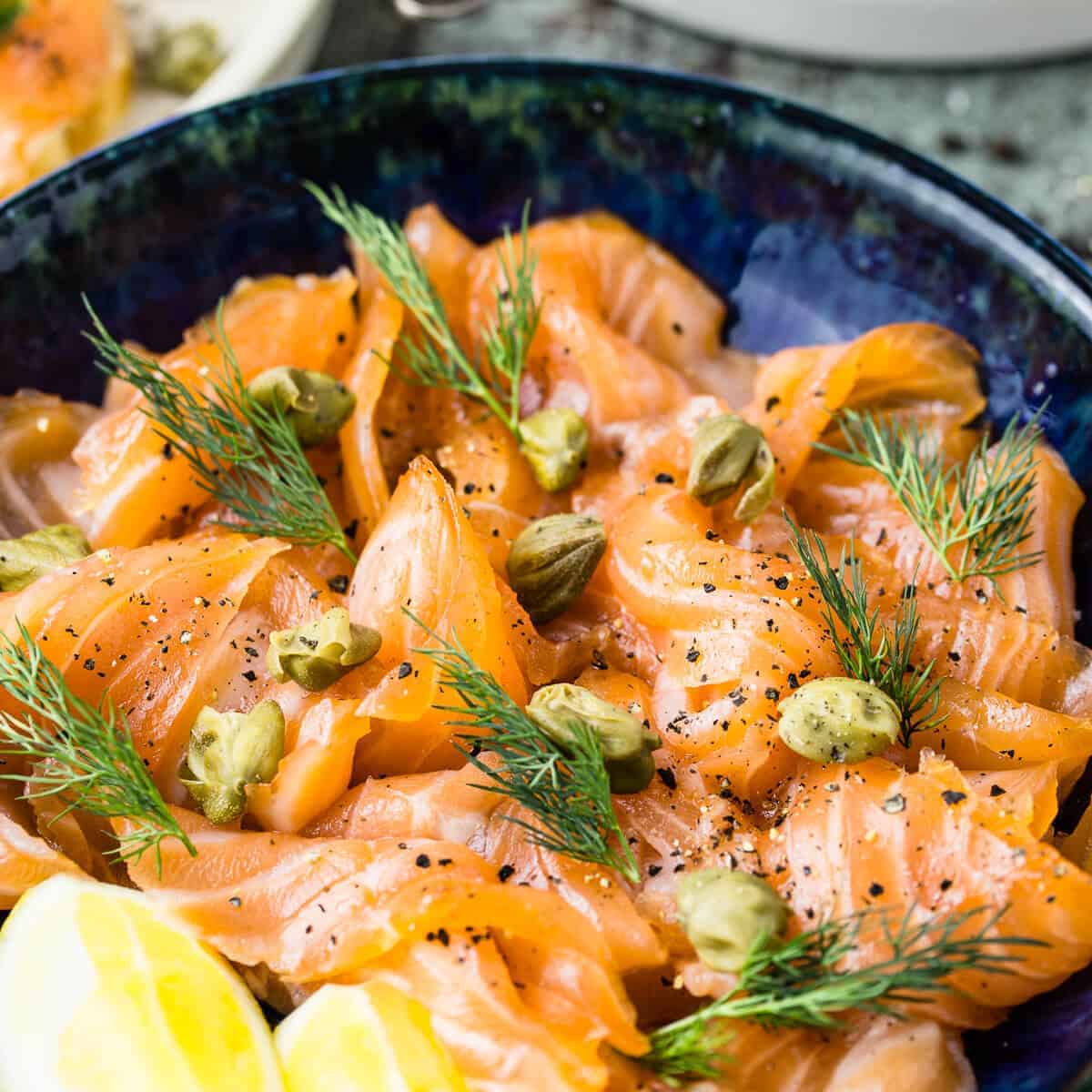 sliced cured salmon gravlax with dill and capers