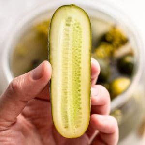 fermented cucumber cut in half.
