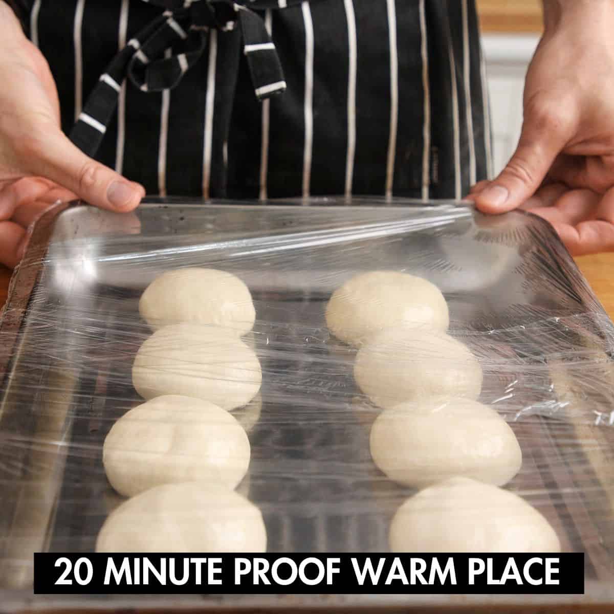 Naan balls on a covered tray ready for final proof.