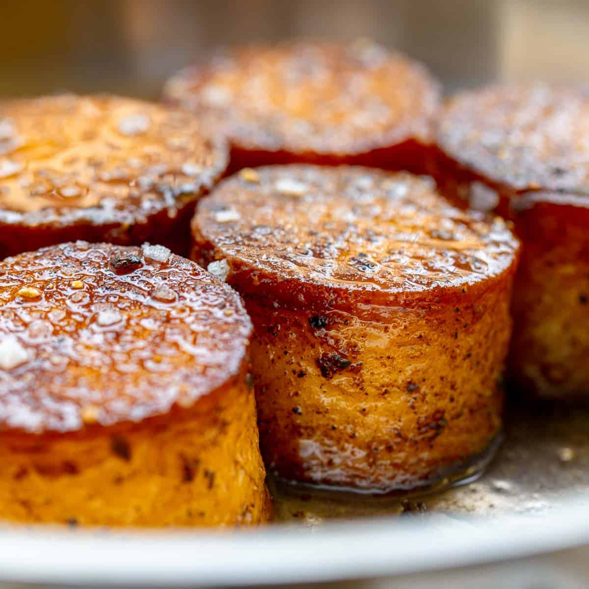 Close up of cooked potato fondants in stainless steel pan.