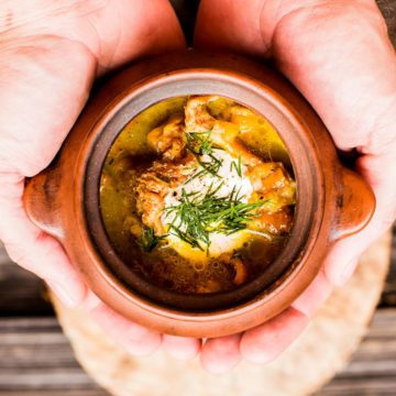 Chanterelle mushroom soup in a brown bowl.