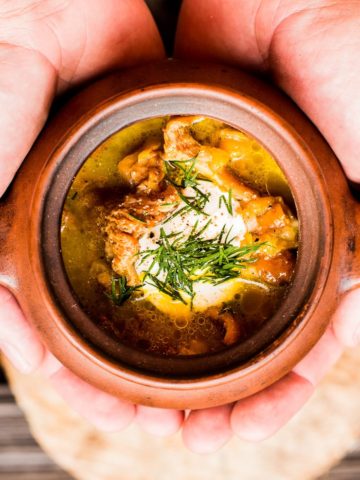 Chanterelle mushroom soup in a brown bowl.