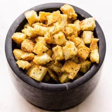 Garlic and herb brioche croutons in a bowl.