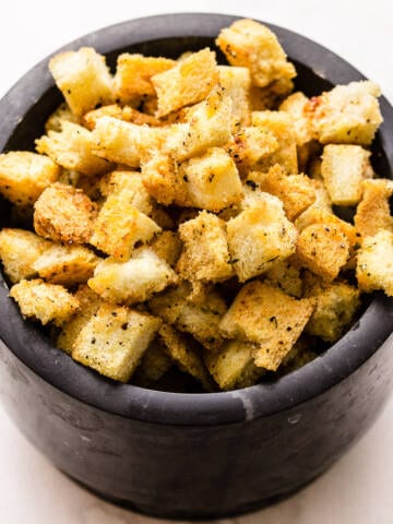 Garlic and herb brioche croutons in a bowl.